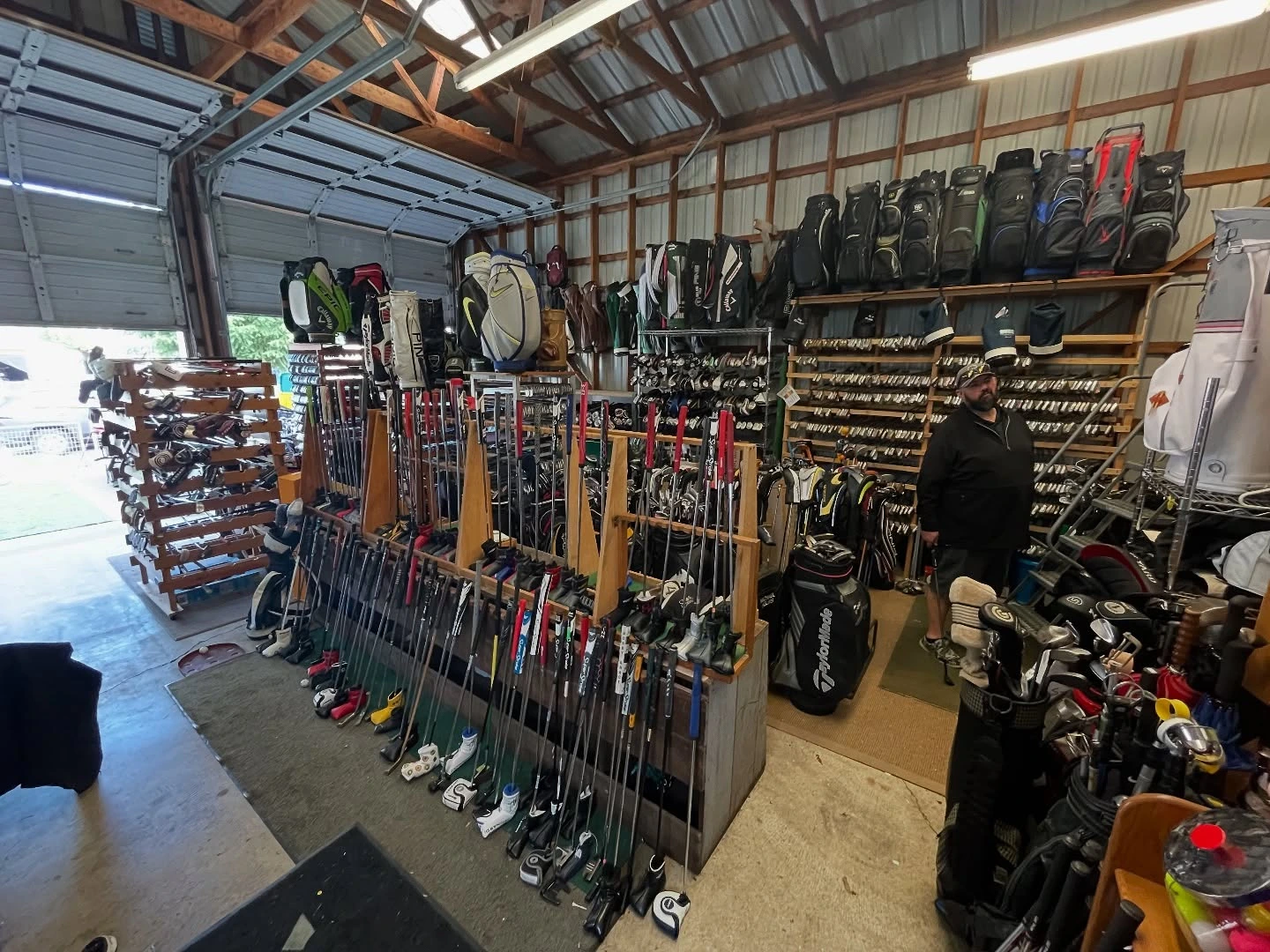 Independent golf shop interior with curated used equipment on display